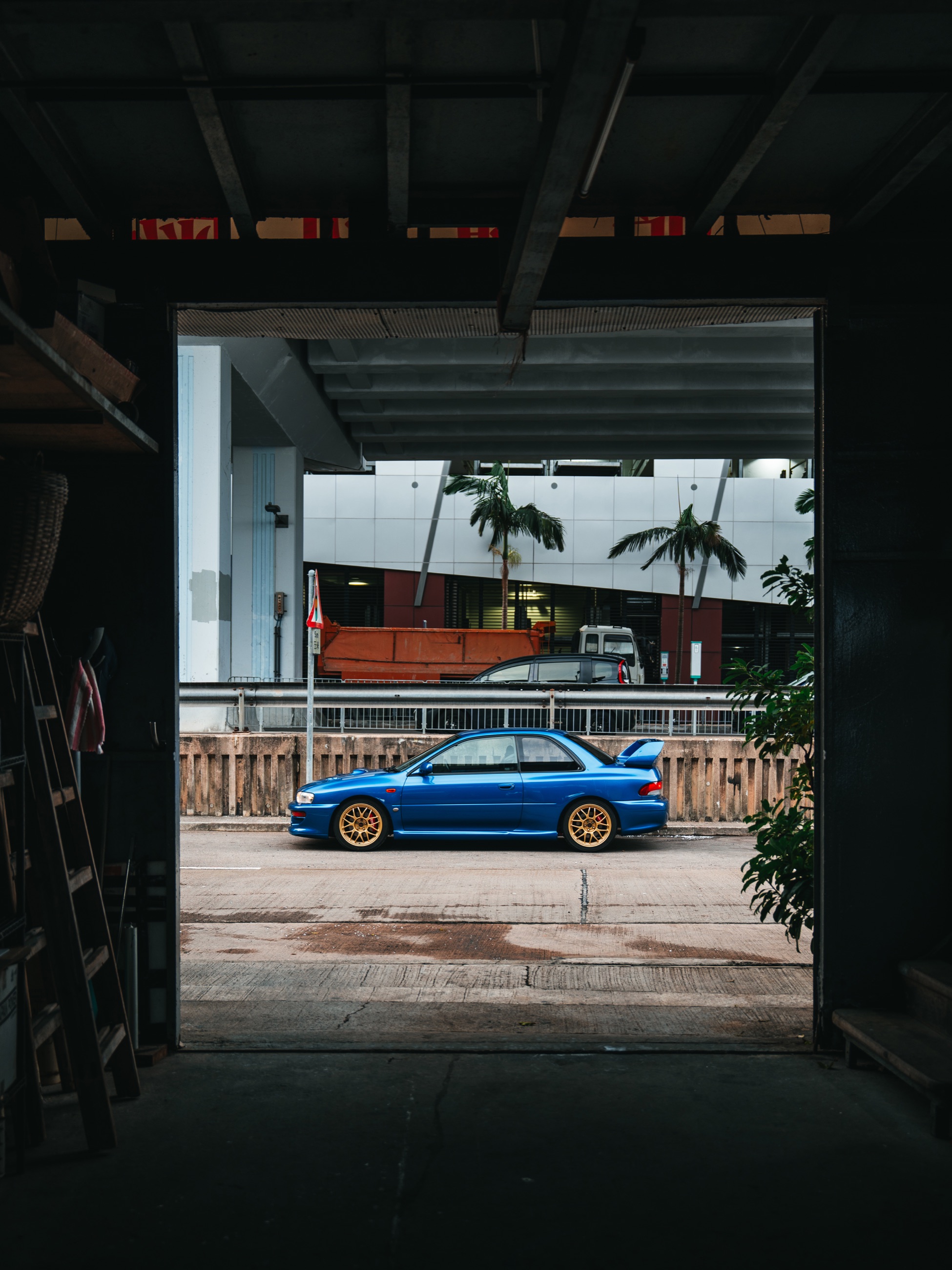 Subaru Impreza 22B STi framed in profile through a Hong Kong passageway