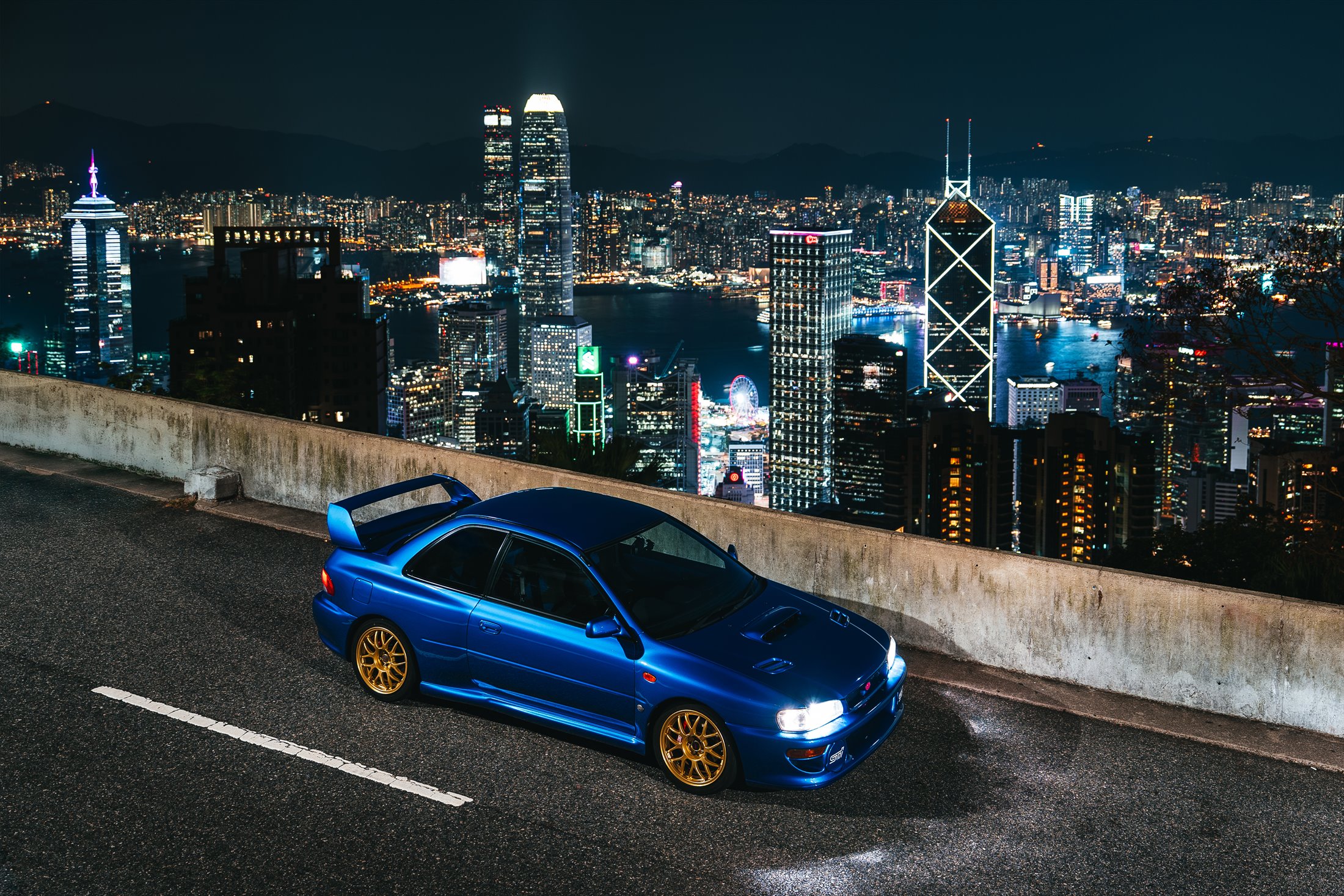 Blue Subaru Impreza 22B STi overlooking the Hong Kong skyline