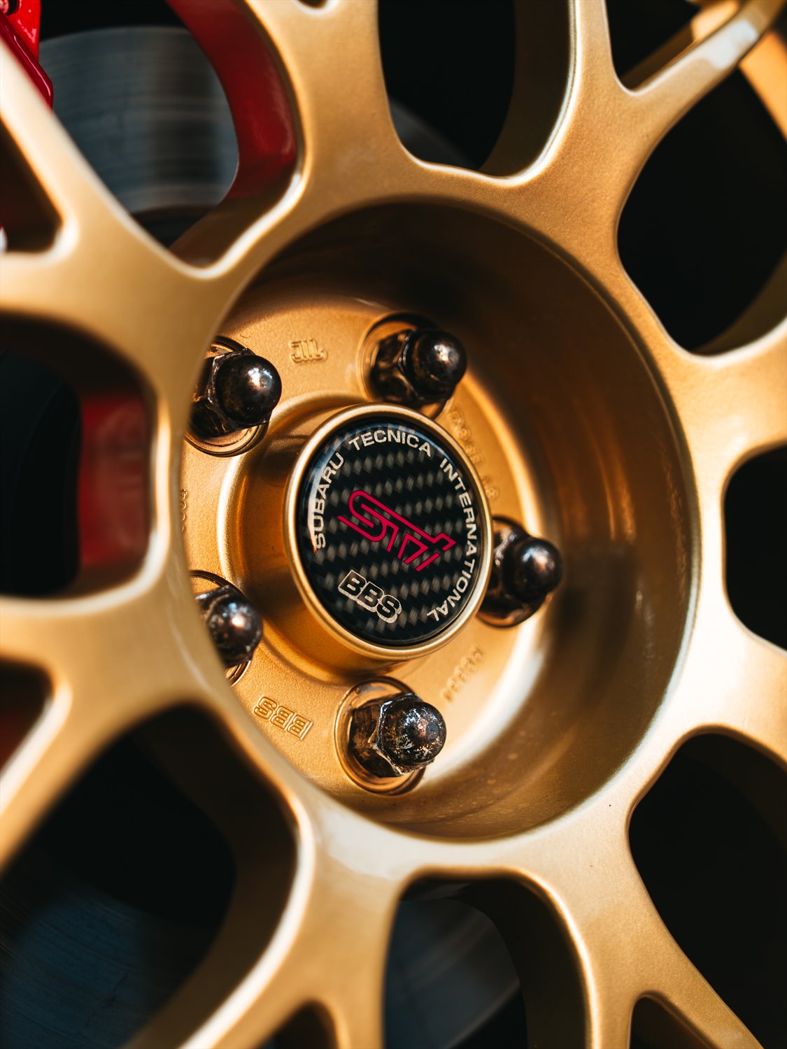 Gold BBS wheel and Subaru Tecnica International centre cap
