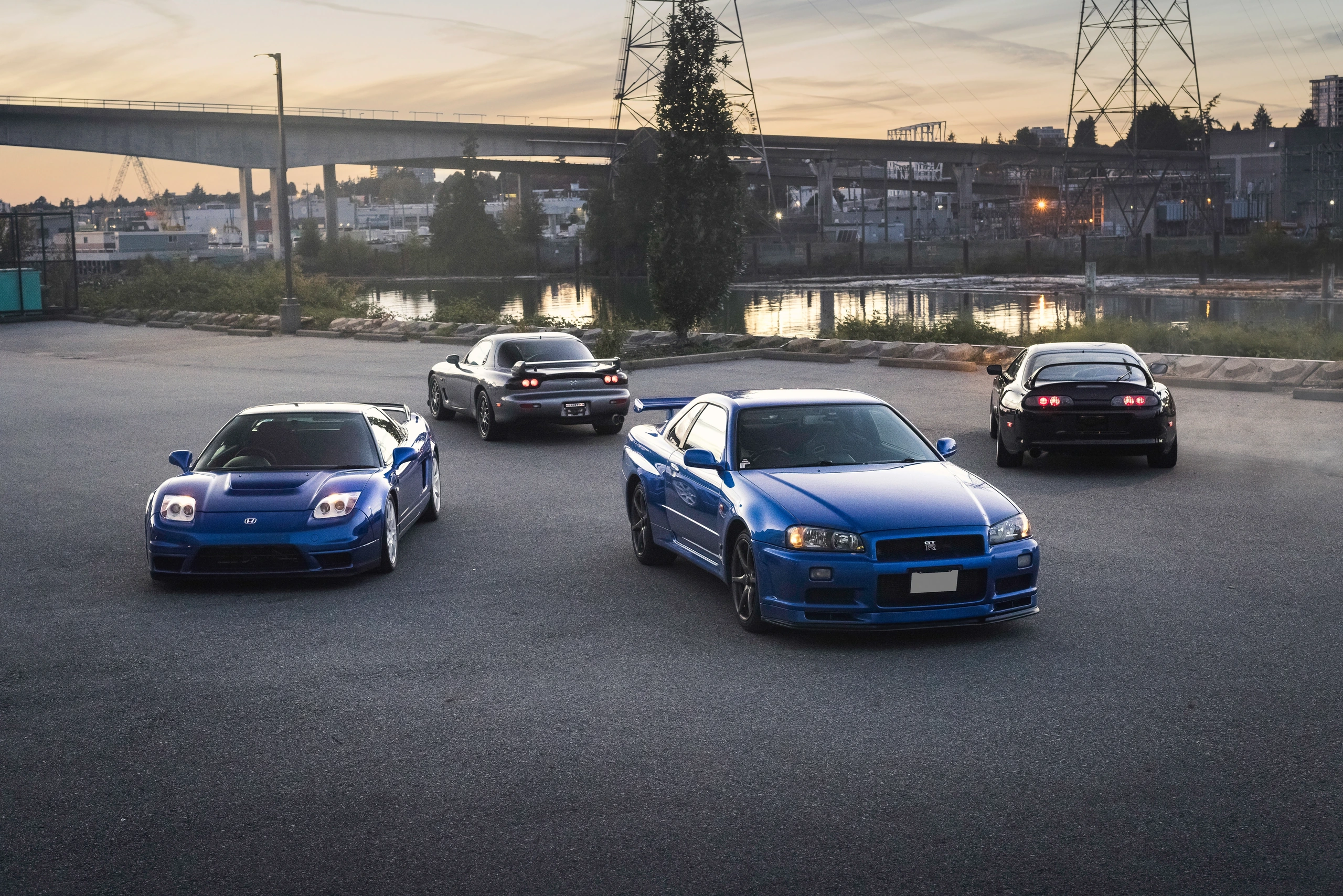 The NSX-R and Skyline GT-R face the camera while the RX-7 and Supra show their rear silhouettes