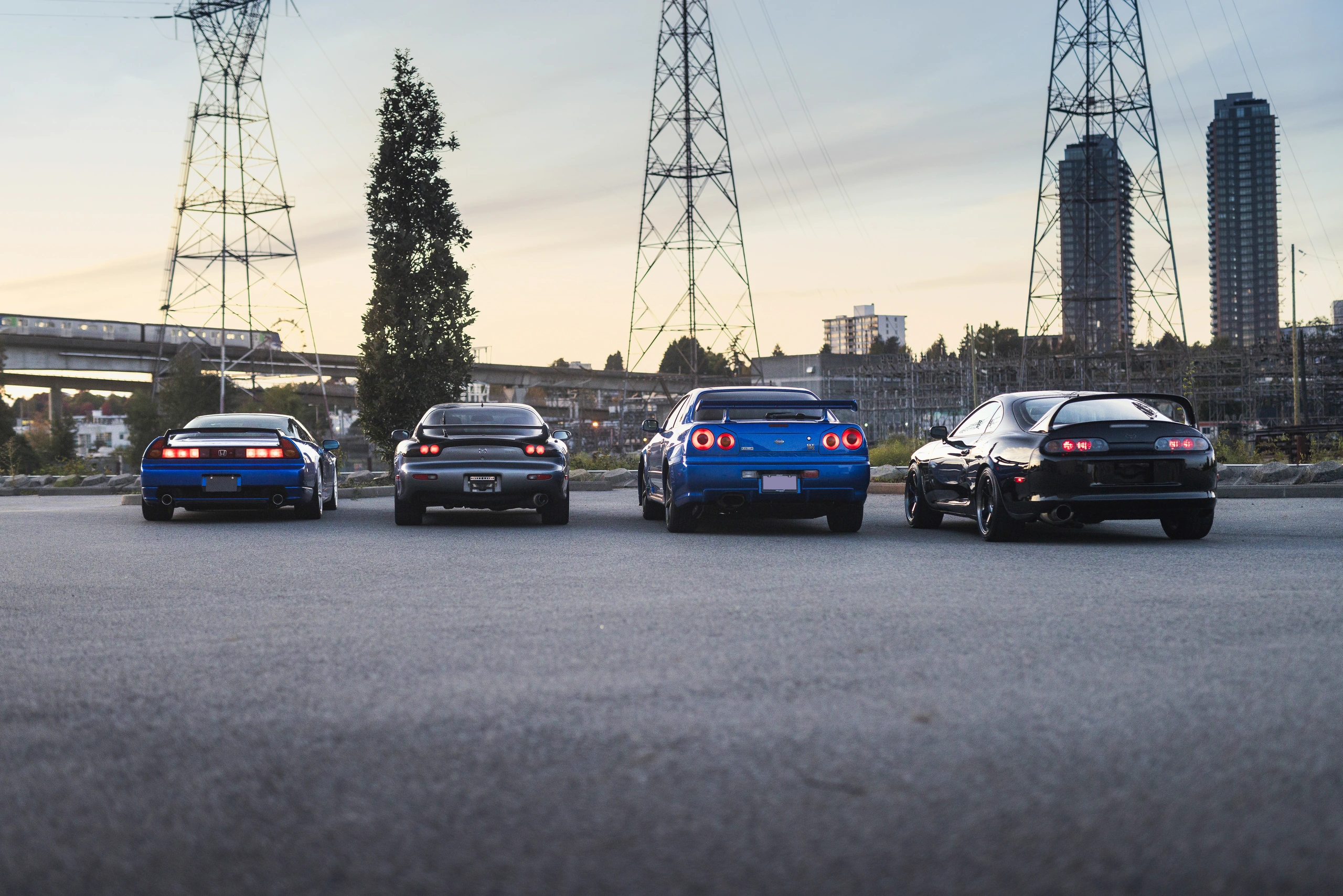 All four Japanese sports cars viewed from behind in the evening light