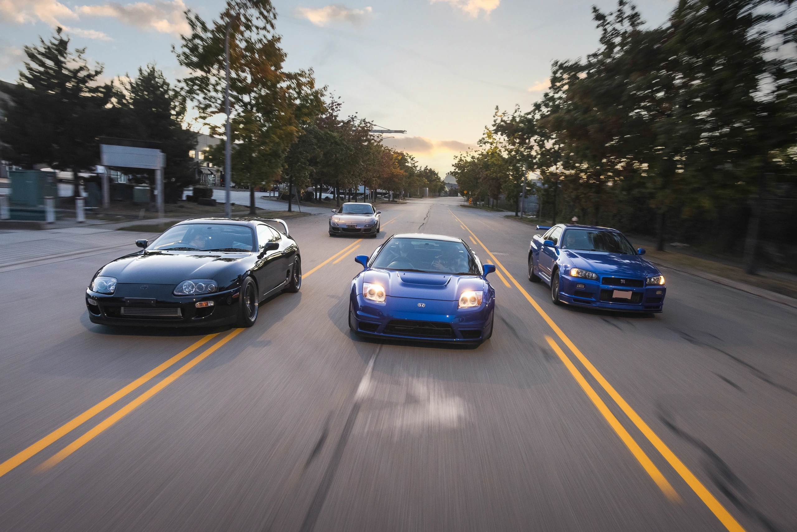 The Supra, NSX-R, RX-7 and Skyline GT-R together on the road at dusk