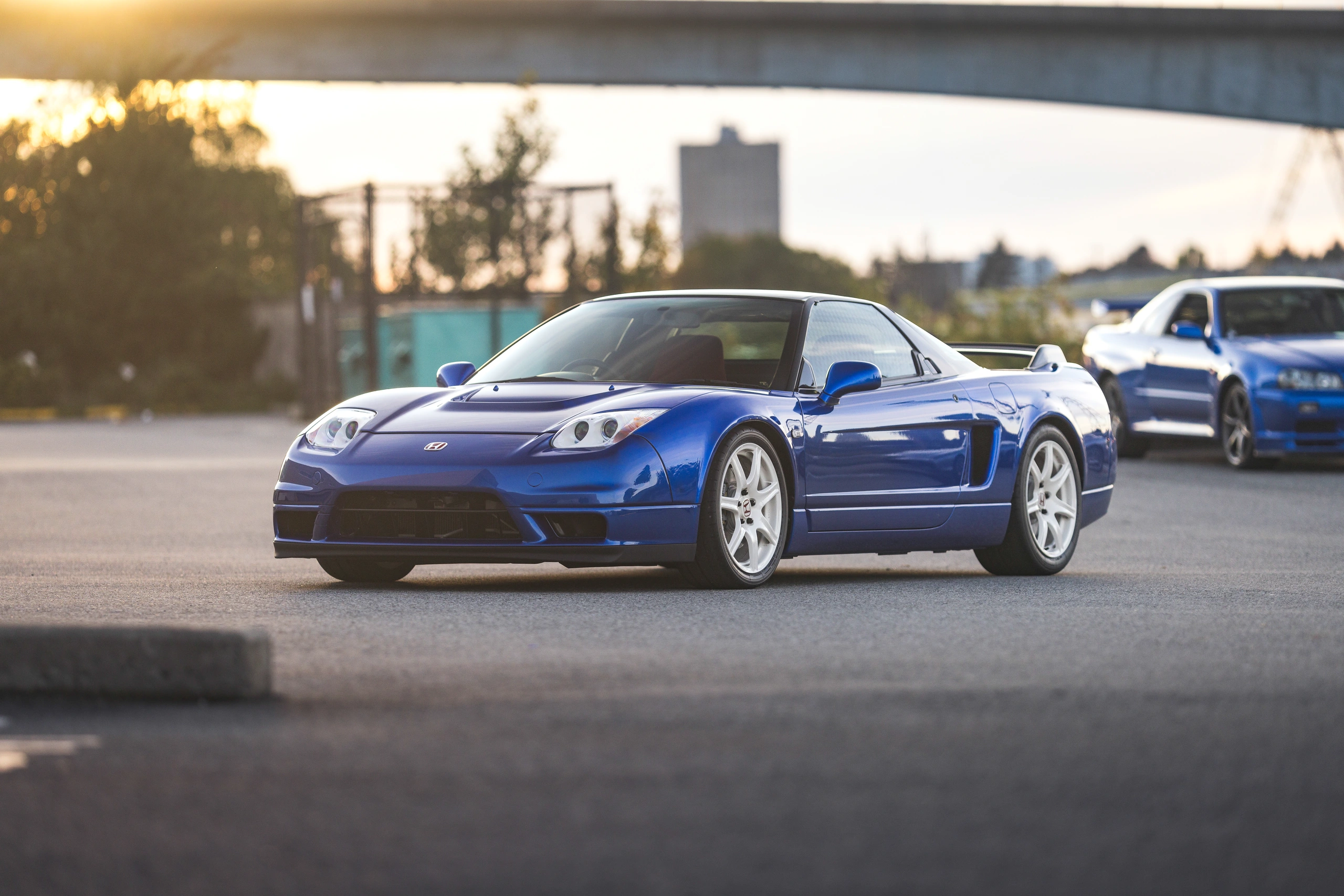 Blue Honda NSX-R in front three-quarter view beneath the evening sky