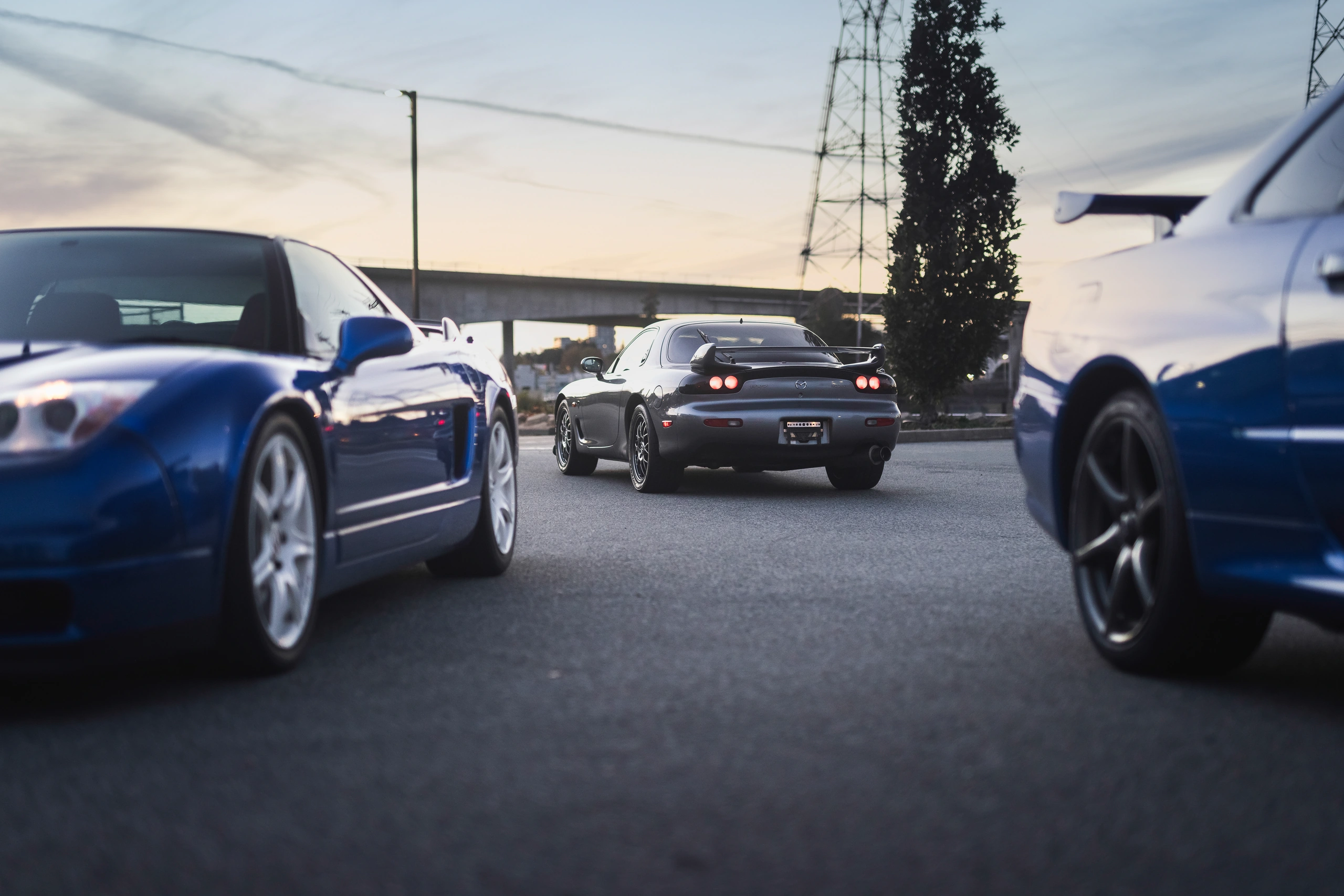 The RX-7 rear silhouette framed between the NSX-R and Skyline GT-R